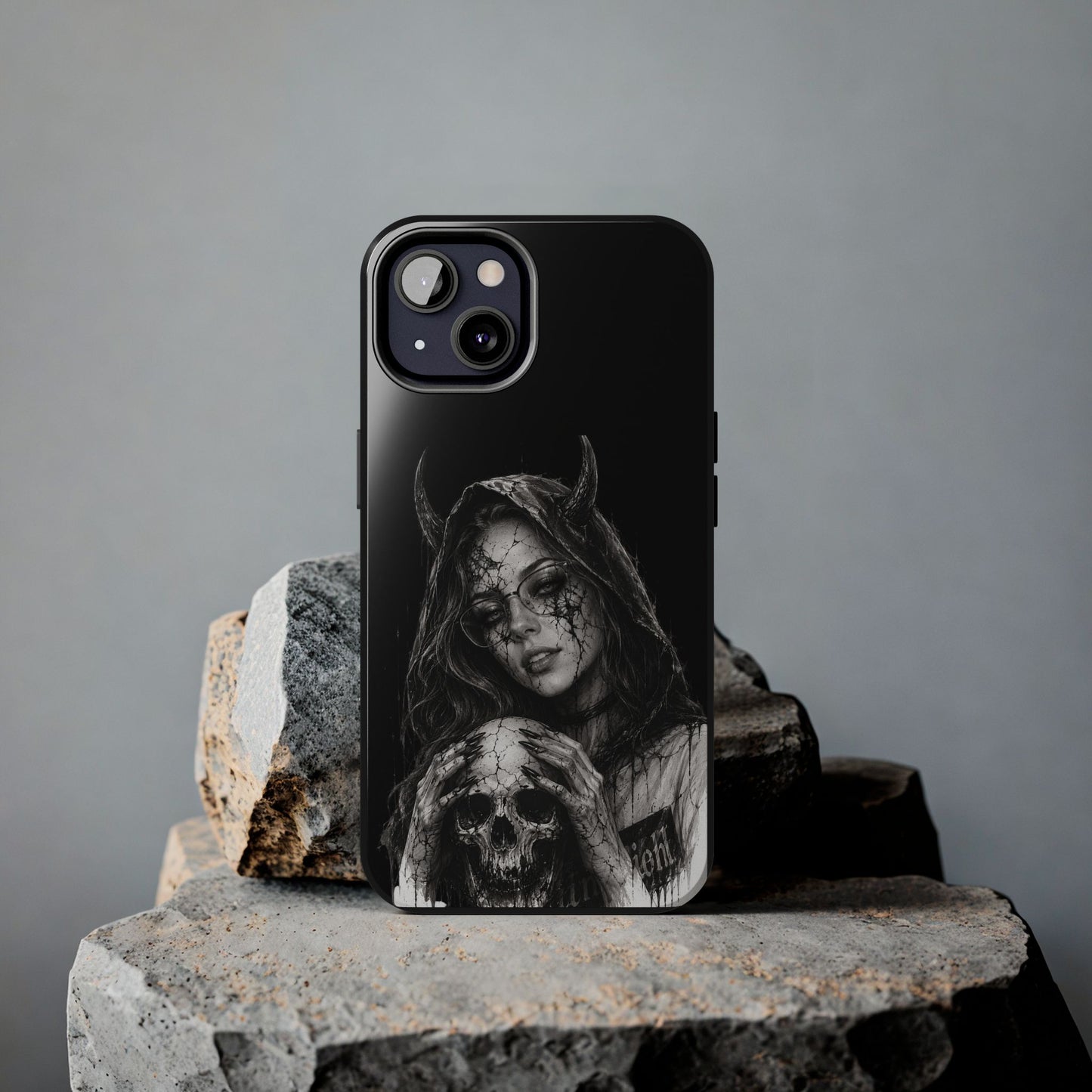 Phone case with a design of a hooded figure holding a skull on a gray background