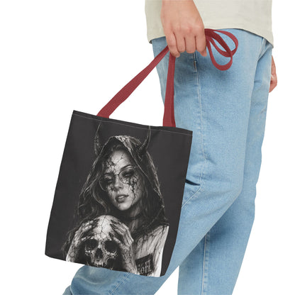 Person holding a tote bag with a graphic design of a woman and skull.