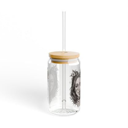 Clear glass tumbler with wooden lid and straw on a white background