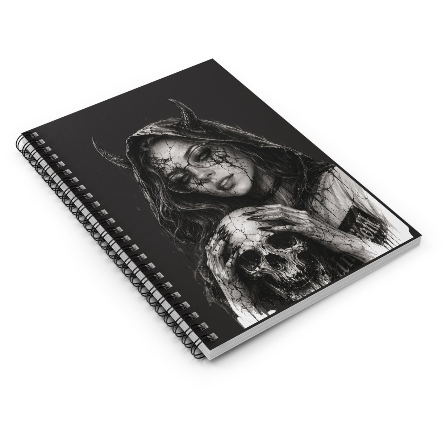 Spiral-bound notebook with a black and white illustration of a woman with horns on the cover.