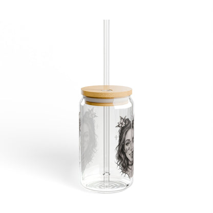 Clear tumbler with bamboo lid and straw on a white background