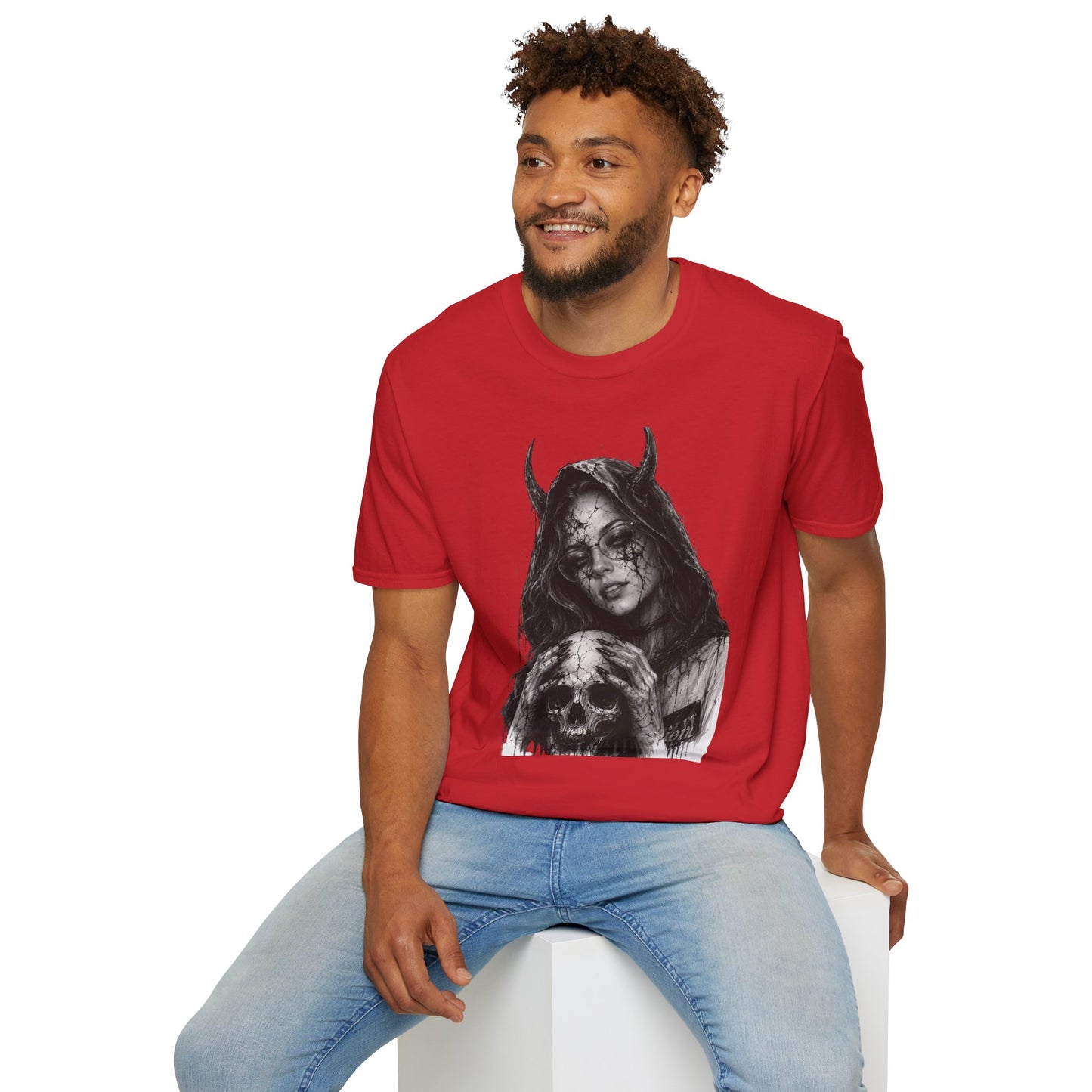 Man wearing a red t-shirt with a graphic design sitting on a white stool against a white background