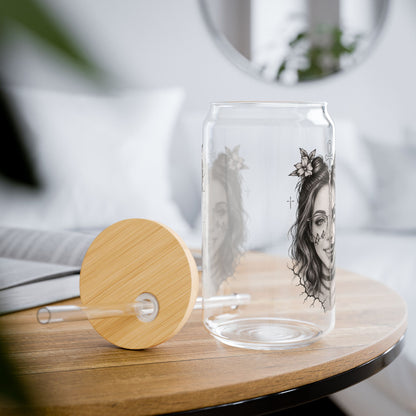 Clear glass carafe with wooden lid and artistic design on a table